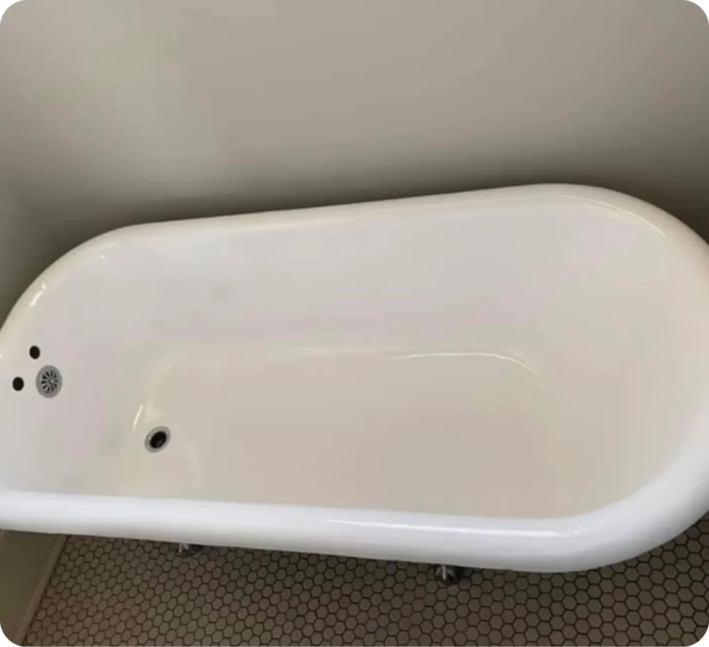 Clawfoot bathtub after professional reglazing in Lindenhurst , NY — bright white glossy finish restored