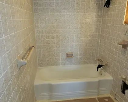 Bathtub and tile surround during professional reglazing service in Lindenhurst , NY — Nassau County refinishing