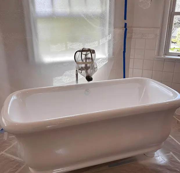 Freestanding bathtub after professional reglazing in Lindenhurst ,NY — restored bright white finish
